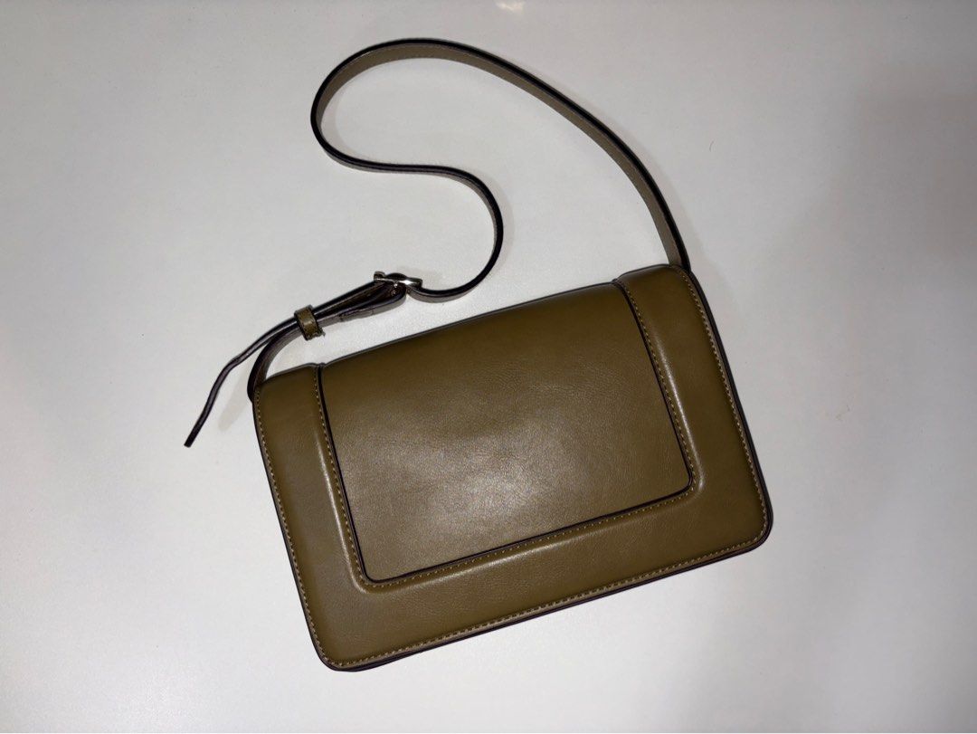 Mango Olive Green Shoulder Bag (Category: Cross-body Bags) located in Quezon City. Submitted by vvelcometomyshop (Listing ID 1465754866, Image 1). Description: - Style: Olive green leather crossbody bag with clean, structured lines - Design: Front flap with stylish stitched panel detail and metal hardware - Versatility: Deep earthy tone that matches casual outfits and evening wear - Capacity: Compact size that easily fits your phone, keys, and ca