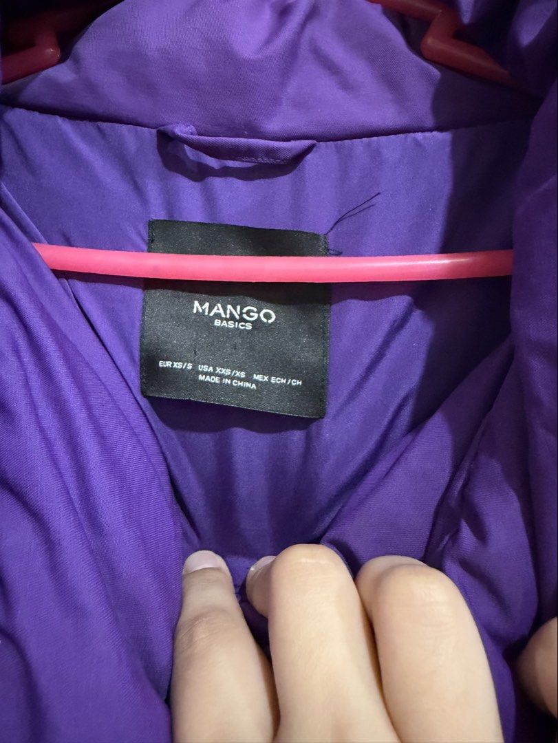 Mango Winter Puffer Jacket Coat Size XS (Category: Coats, Jackets and Outerwear) located in Manila. Submitted by preloved_new_forsale (Listing ID 1465633730, Image 2). Description: - Brand: Mango Basics - Color: Vibrant Purple - Size: EUR XS/S (USA XXS/XS, MEX ECH/CH) - Style: Mid-length puffer coat with high collar and front tie detail - Features: Warm quilted design and deep side pockets - Origin: Made in China - Condition: Great winter jacket 