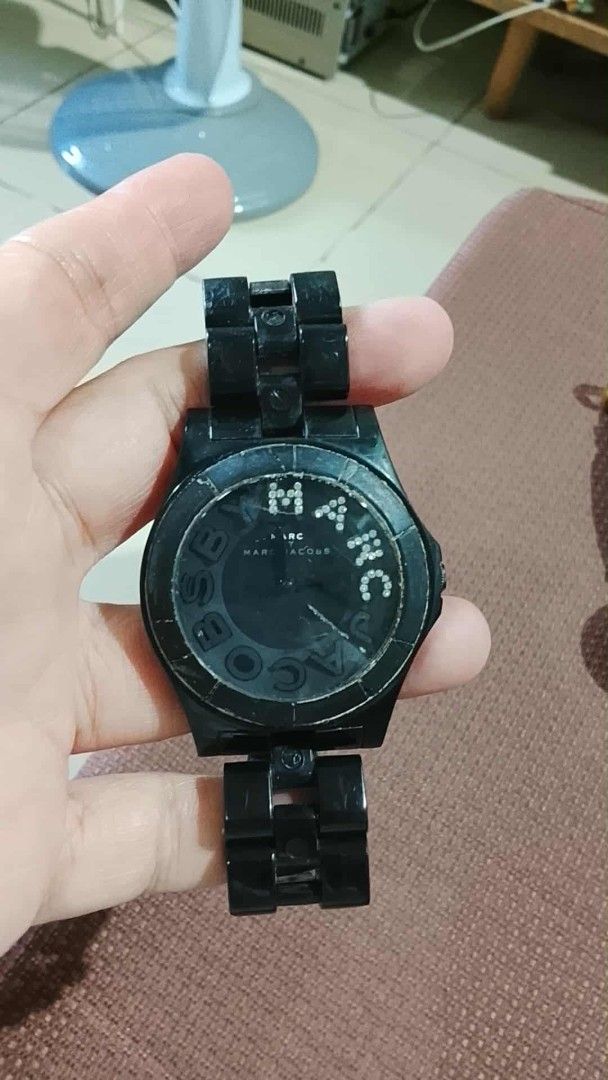 Marc by Marc Jacobs black link watch (Category: Women's Watches) located in Bacoor. Submitted by lothea618 (Listing ID 1465614386, Image 1). Description: - Brand: Marc by Marc Jacobs - Color/Material: Black watch with chunky plastic links - Design: Crystal embellishments spelling out the brand name around the face - Condition: Normal wear on bezel and band; battery needs replacing (hands currently stopped) - Closure: Clasp closure in good working