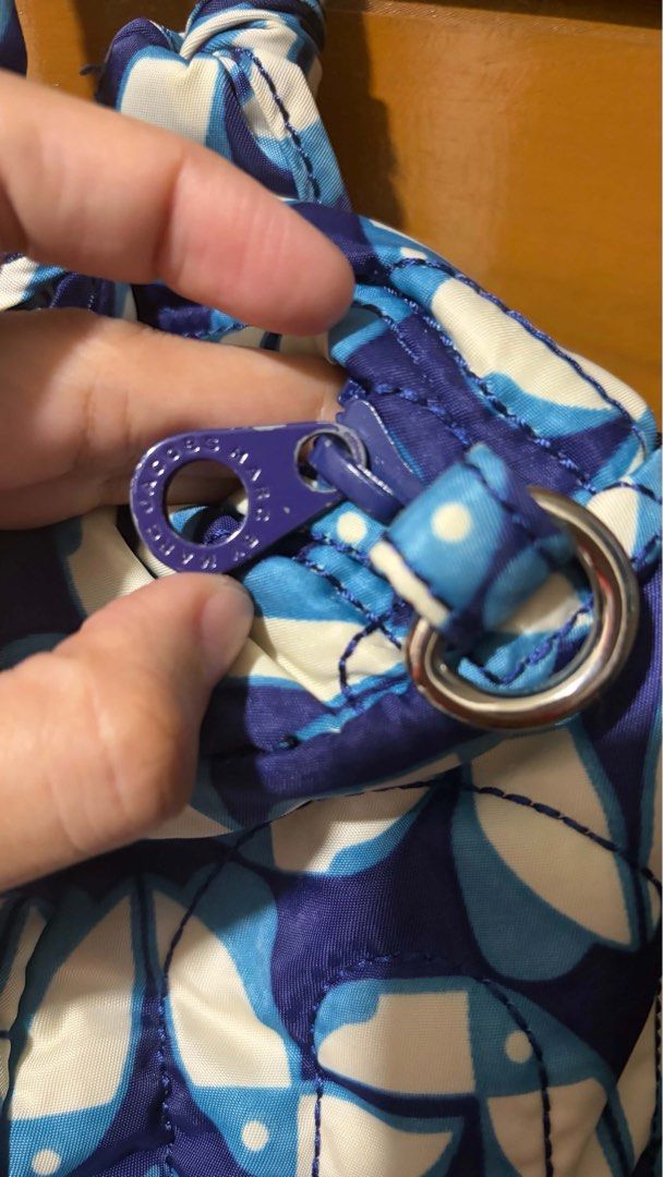 Marc by Marc Jacobs Quilted Workwear Handbag (Category: Luxury Bags & Wallets) located in Manila. Submitted by its.chie (Listing ID 1465719978, Image 3). Description: Quilted fabric handbag by Marc by Marc Jacobs. Blue and white abstract pattern throughout. Double top handles with knotted base details. Zip top closure with branded pull. Inside features a zippered pocket plus two slip pockets. Clean blue lining. Silver hardware accents and signatu