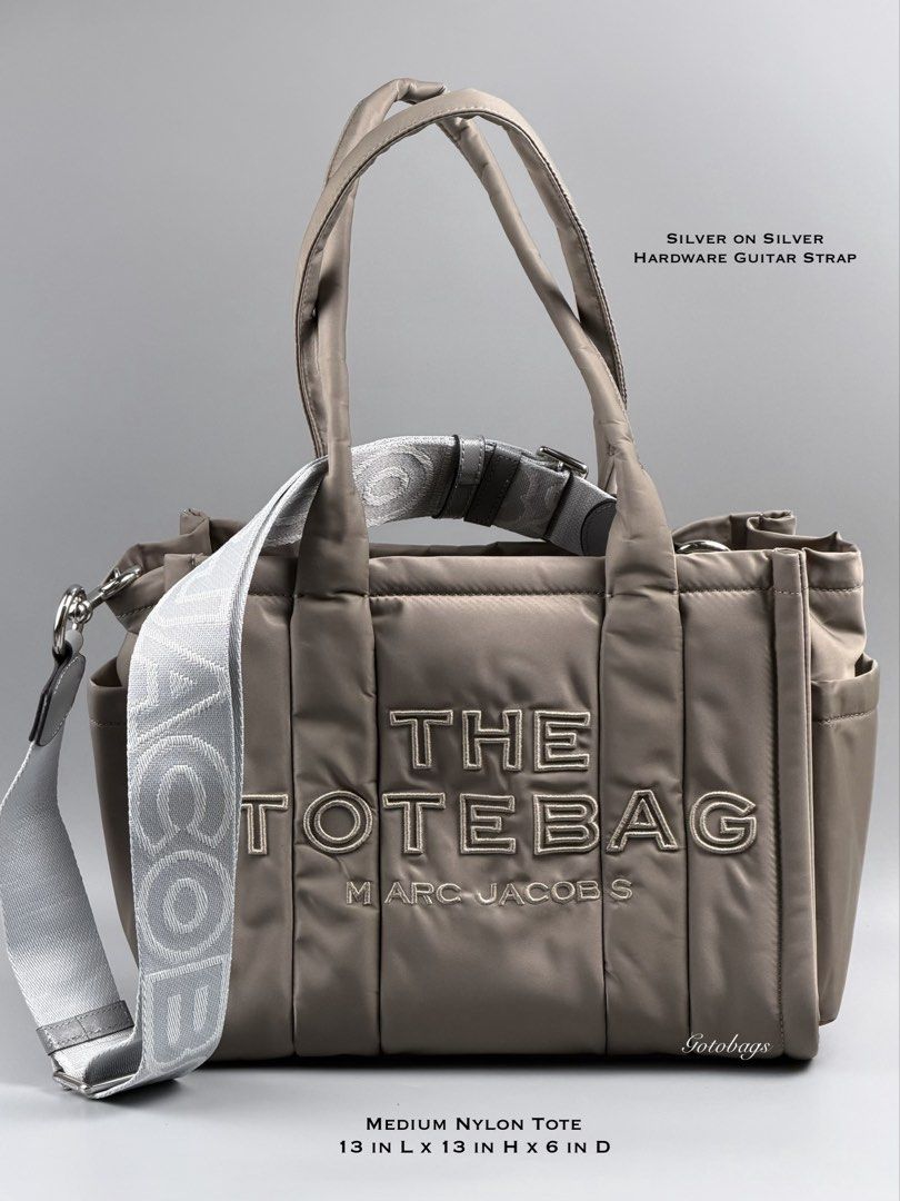 Marc Jacobs The Tote Bag Medium Nylon Silver (Category: Luxury Bags & Wallets) located in Angeles City. Submitted by gobagsto (Listing ID 1440282336, Image 1). Description: - Medium size Marc Jacobs nylon tote bag - CEMENT - Signature 'The Tote Bag' embroidered logo on front - Top handles - Detachable shoulder strap with 'The Tote Bag' text - Multiple exterior pockets for easy access - Interior zip pocket - Bright orange lining.