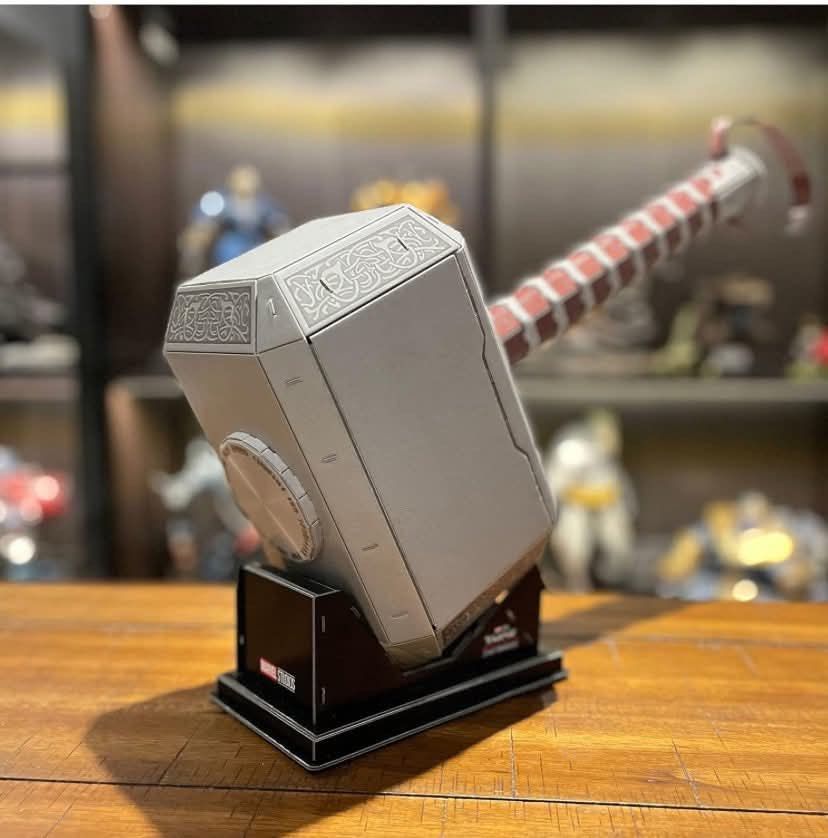 Marvel Studios Thor's Hammer Mjolnir 3D Paper Model Kit (Category: Figurines & Statues) located in Cagayan de Oro. Submitted by sethmarko27 (Listing ID 1465581292, Image 1). Description: - Official Marvel Studios Thor Mjolnir 3D paper model kit by 4D Build - Includes 84 puzzle pieces for a fun DIY assembly project - Recommended for ages 8 and up - Finished model comes with a sturdy display stand - Assembled dimensions: approx. 18.9" long x 21.46"