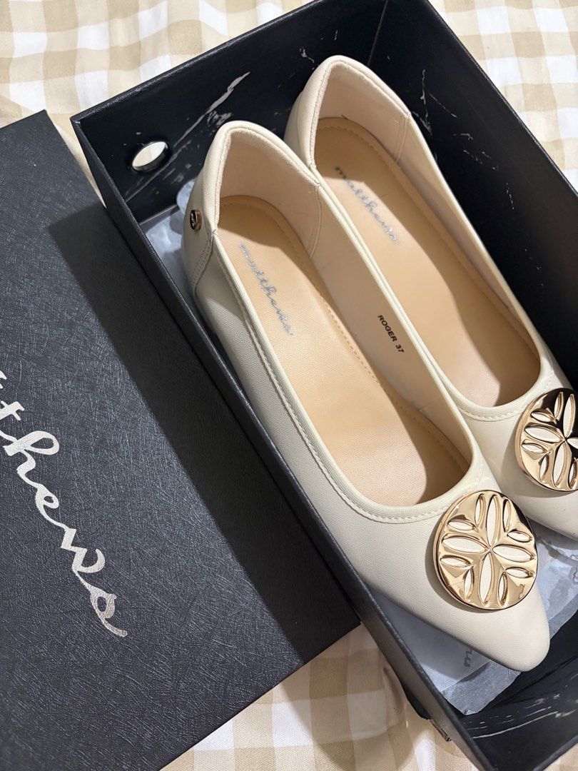 Matthews Roger Cream Pointed Toe Flats Size 37 (Category: Flats & Sandals) located in Caloocan City. Submitted by mllndg (Listing ID 1465706846, Image 2). Description: - Brand: Matthews - Style: Pointed flats with low block heel - Color: Cream with gold-tone decorative toe medallion - Size: 37 (marked inside and on sole) - Condition: Worn once, very minor wear on soles - Inclusions: Original black shoebox.