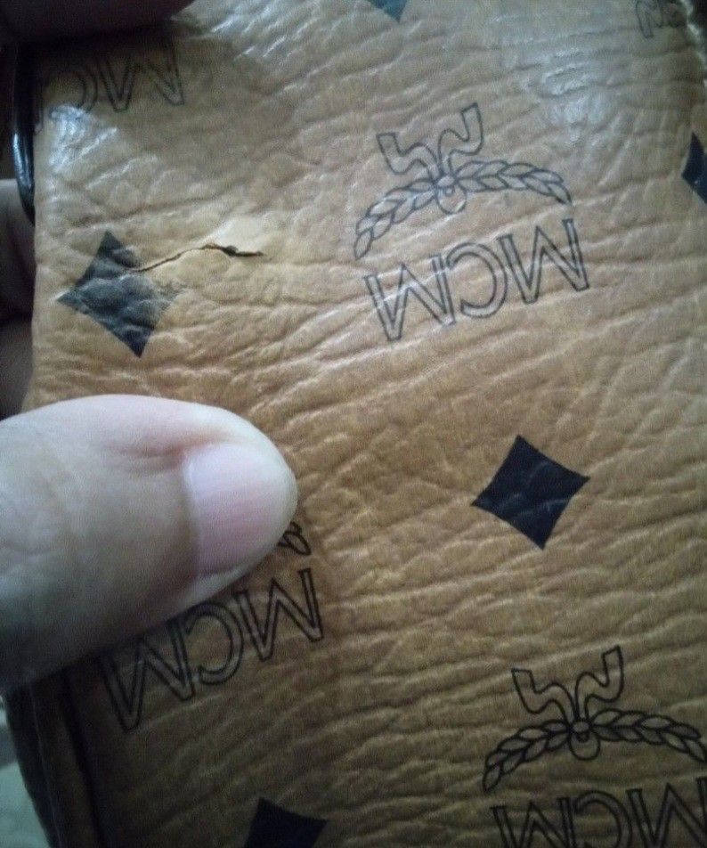 MCM Monogram Cognac Tote Bag (Category: Luxury Bags & Wallets) located in Cabanatuan. Submitted by almaespino24263 (Listing ID 1465639968, Image 2). Description: - Authentic MCM tote bag in classic cognac brown - Iconic all-over Visetos monogram print - Double shoulder straps with stylish gold-tone buckles and hardware - Secure zip top closure and front plaque detail - Spacious interior perfect for daily essentials - Condition note: Back Minor cr