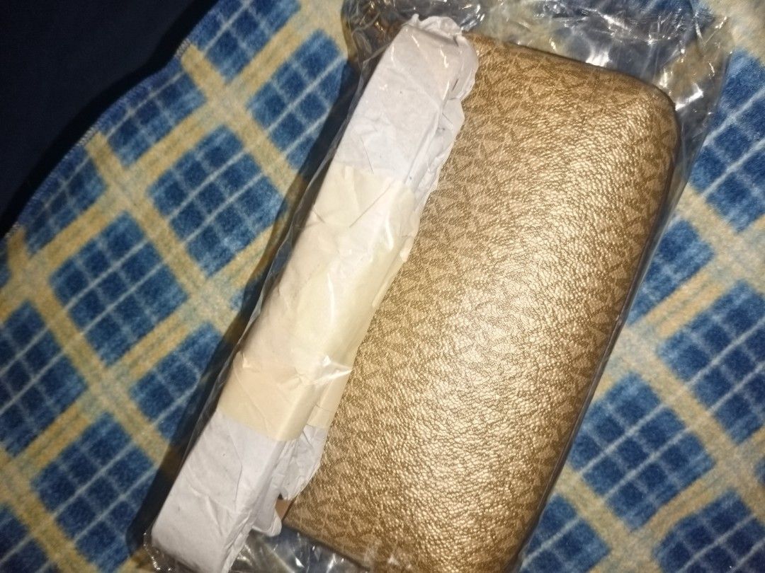 Michael Kors Gold Wallet (Category: Wallets & Card holders) located in Baguio. Submitted by valenzuela.jc (Listing ID 1465698791, Image 2). Description: Sourced from America - Authentic gold Michael Kors wallet - Brand new and unopened in original plastic wrap - Stylish textured finish with signature logo print - Securely wrapped with protective paper bands straight from storage - Ideal for daily use or as a special gift.