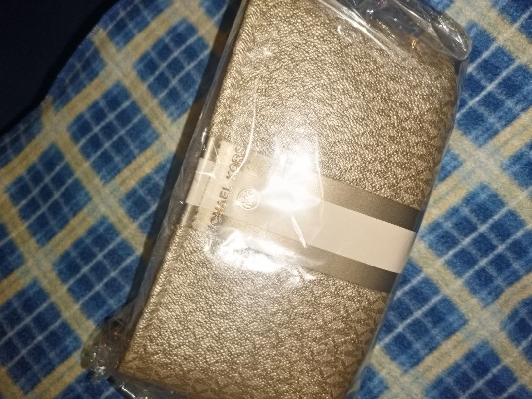 Michael Kors Gold Wallet (Category: Wallets & Card holders) located in Baguio. Submitted by valenzuela.jc (Listing ID 1465698791, Image 1). Description: Sourced from America - Authentic gold Michael Kors wallet - Brand new and unopened in original plastic wrap - Stylish textured finish with signature logo print - Securely wrapped with protective paper bands straight from storage - Ideal for daily use or as a special gift.