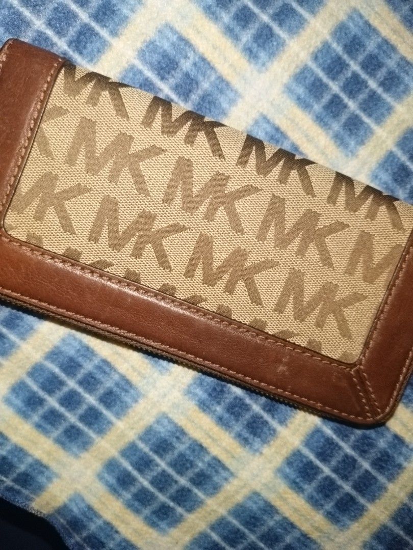 Michael Kors MK Monogram Brown Leather Zip Around Wallet (Category: Luxury Bags & Wallets) located in Baguio. Submitted by valenzuela.jc (Listing ID 1465699606, Image 2). Description: Sourced from Canada - Brand: Michael Kors - Design: Classic brown monogram print with solid brown leather trim and gold-tone hardware - Closure: Smooth zip-around action - Interior: Multiple card slots, slip pockets, and a secure zippered coin compartment - Conditio