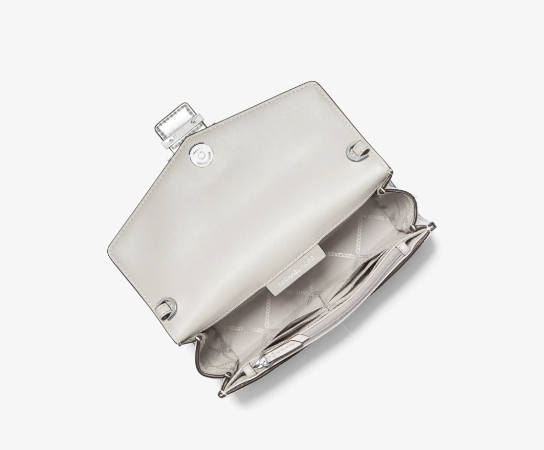 Michael Kors Penelope Medium Silver Clutch $258 BNWT Formal (Category: Luxury Bags & Wallets) located in Las Pinas. Submitted by anonymously_shopaholic (Listing ID 1465721535, Image 2). Description: Brand new with tags but the silver chain strap was misplaced, so this is just the clutch bag. - Brand: Michael Kors - Style: Penelope Medium Clutch - Color/Finish: Silver Metallic - Features: Crystal-embellished buckle closure, removable chain strap f