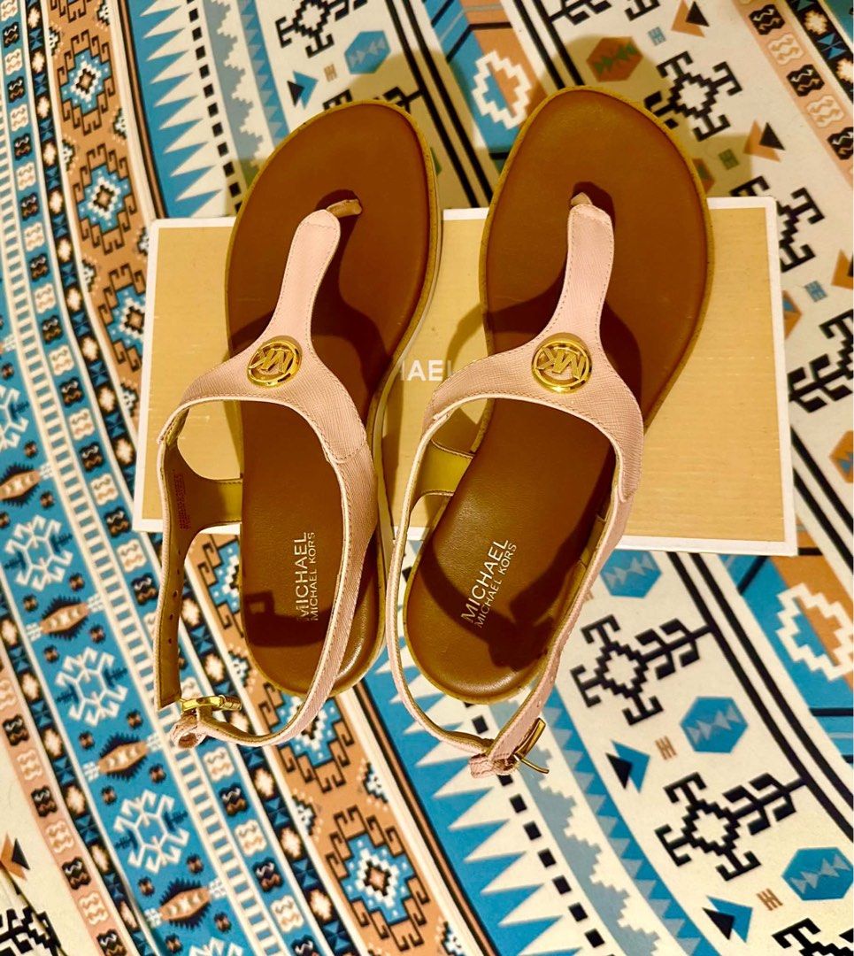 Michael Kors Pink T-Strap Sandals with Original Box (Category: Flats & Sandals) located in Manila. Submitted by anonymous123.149 (Listing ID 1465677272, Image 1). Description: - Brand: Michael Kors - Color: Pink with brown footbeds - Details: Signature gold-tone MK logo hardware on front straps - Closure: Ankle straps with adjustable gold buckles - Inclusions: Original Michael Kors shoebox included - Condition: Excellent, stylish and ready to wea