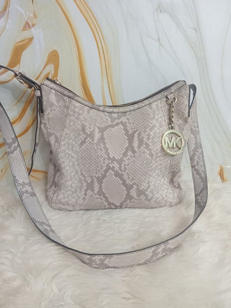 Michael Kors Python Embossed Shoulder Bag (Category: Luxury Bags & Wallets) located in Cabadbaran. Submitted by lioness_cave (Listing ID 1465735460, Image 1). Description: Michael Kors shoulder bag in a neutral python print. Faux snakeskin leather exterior paired with gold-tone hardware and signature MK charm hanging from the strap. Zip top closure opens to branded fabric lining with interior pockets. Inside tag shows style number 35F6GFTM3E, mad