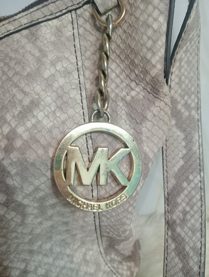 Michael Kors Python Embossed Shoulder Bag (Category: Luxury Bags & Wallets) located in Cabadbaran. Submitted by lioness_cave (Listing ID 1465735460, Image 2). Description: Michael Kors shoulder bag in a neutral python print. Faux snakeskin leather exterior paired with gold-tone hardware and signature MK charm hanging from the strap. Zip top closure opens to branded fabric lining with interior pockets. Inside tag shows style number 35F6GFTM3E, mad