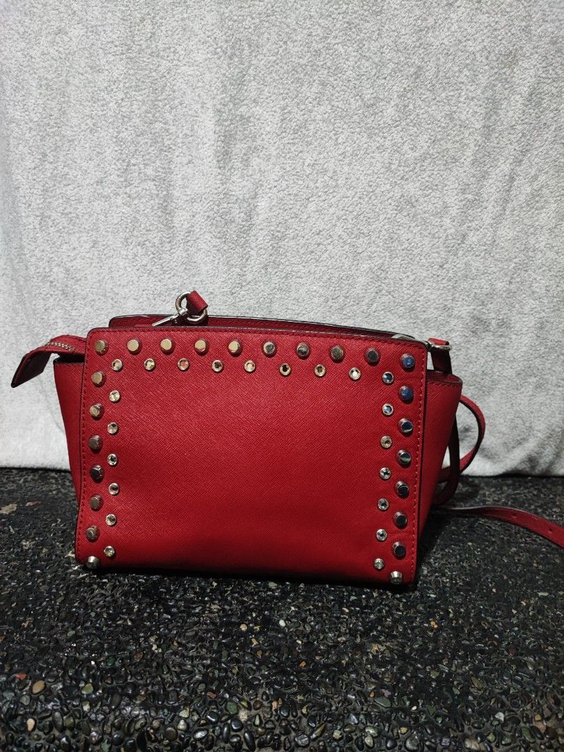 Michael Kors Red Studded Crossbody Bag (Category: Cross-body Bags) located in Baguio. Submitted by ozara.06 (Listing ID 1465699739, Image 3). Description: Michael kors Small size May rubs sa bandang end ng zipper Very nice nya 1k.