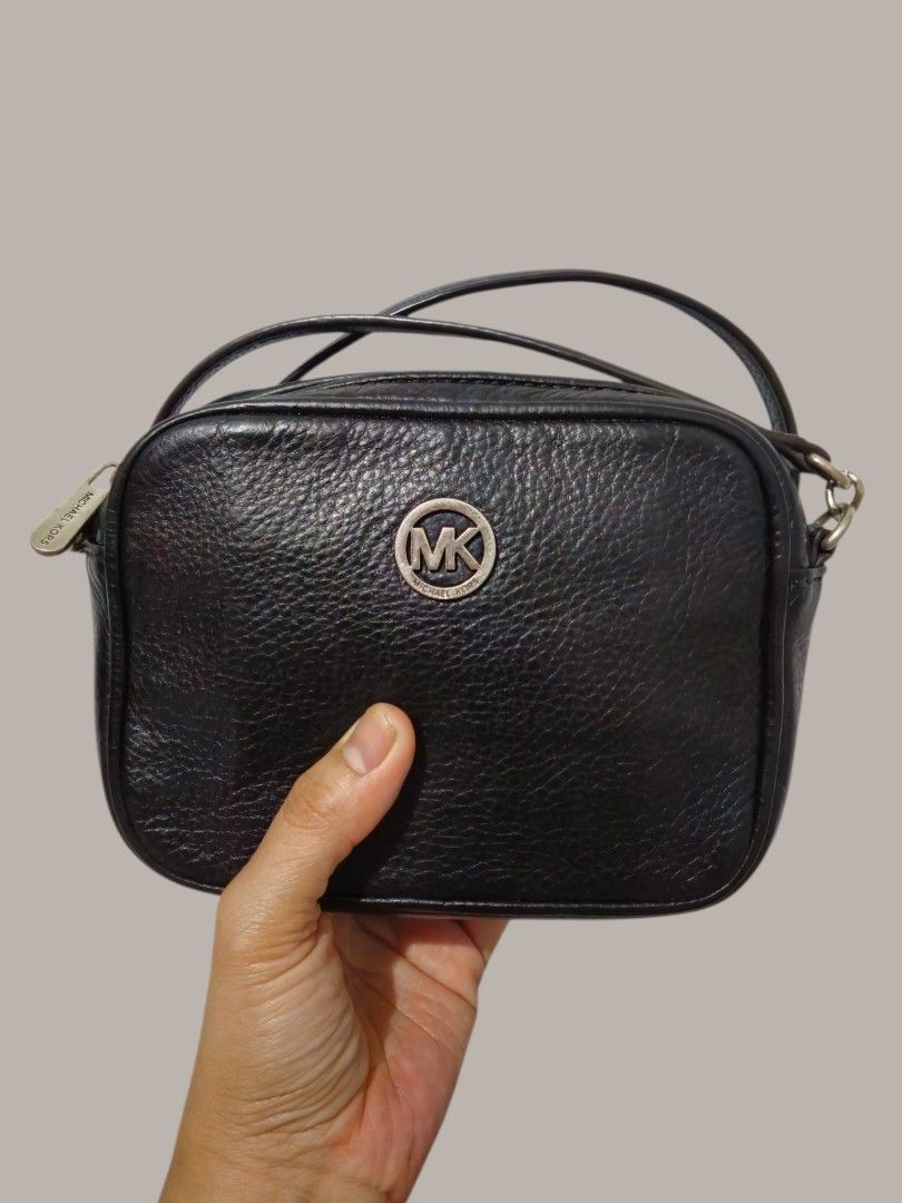 Michael Kors Small Camera Bag (Category: Cross-body Bags) located in Quezon City. Submitted by kirstenbella (Listing ID 1465641559, Image 1). Description: - 💯 Authentic Michael Kors - Premium black pebble leather material - Silver-tone hardware circular MK logo plate - Zip top with branded pull tag - Interior card slots and pocket - H 5" x L 7" x D 2" Inches - NO Issue all intact like new condition - Pickup is welcome or free shipping 📞You may 