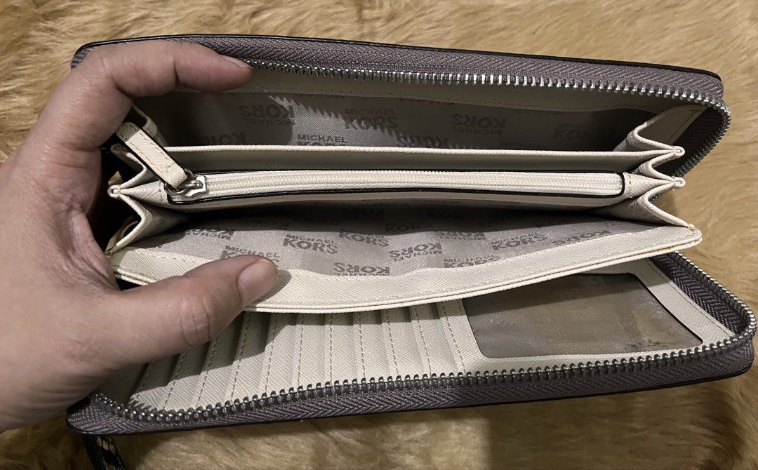 Michael Kors Snake Print Zip Around Wristlet Wallet (Category: Wallets & Card holders) located in Quezon City. Submitted by pickleballpaddle (Listing ID 1465626901, Image 3). Description: - Brand: Michael Kors ORIGINAL - Design: Cream and black snakeskin print with silver-toned hardware - Versatility: Includes a convenient detachable wrist strap - Interior: Cream lining with repeated logo print - Storage: Multiple card slots, slip compartments, a