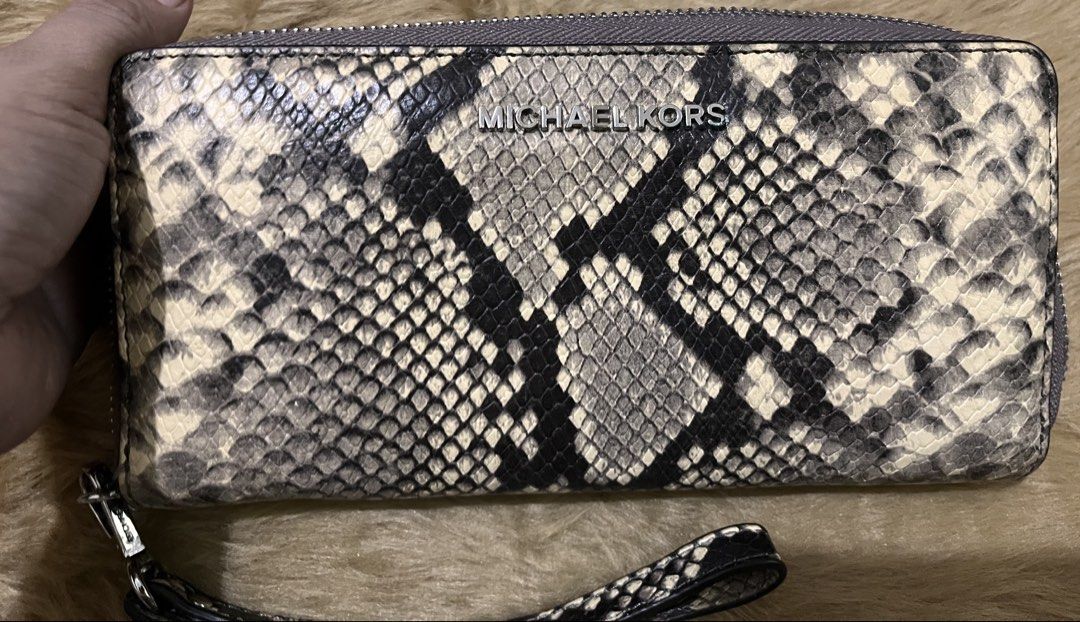 Michael Kors Snake Print Zip Around Wristlet Wallet (Category: Wallets & Card holders) located in Quezon City. Submitted by pickleballpaddle (Listing ID 1465626901, Image 1). Description: - Brand: Michael Kors ORIGINAL - Design: Cream and black snakeskin print with silver-toned hardware - Versatility: Includes a convenient detachable wrist strap - Interior: Cream lining with repeated logo print - Storage: Multiple card slots, slip compartments, a