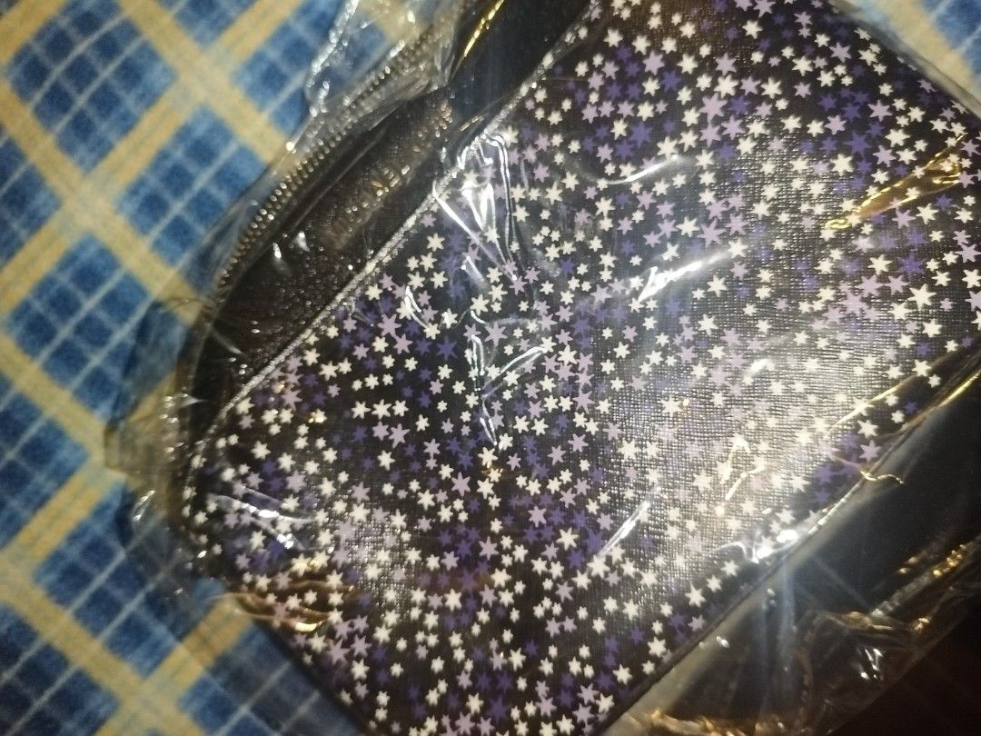 Michael Kors Starry Print Crossbody Bag (Category: Cross-body Bags) located in Baguio. Submitted by valenzuela.jc (Listing ID 1465698566, Image 1). Description: - Brand: Michael Kors - Style: Dome crossbody bag - Color/Design: Black with a purple and white star pattern - Features: Secure zip closure, branded fabric lining, and built-in internal card slots - Compact and lightweight size, perfect for traveling light - Includes original white Michae