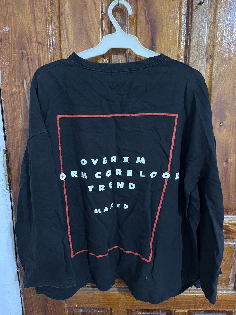 Miggang Black Long Sleeve Graphic Tee (Category: Longsleeves) located in Baguio. Submitted by gbwardrobe (Listing ID 1465615200, Image 2). Description: - Brand: Miggang - Color: Black - Fit: Relaxed fit with crew neckline - Design: White/red "TREND" text on the front chest and a large red-bordered graphic with lettering on the back - Style: Casual everyday streetwear.