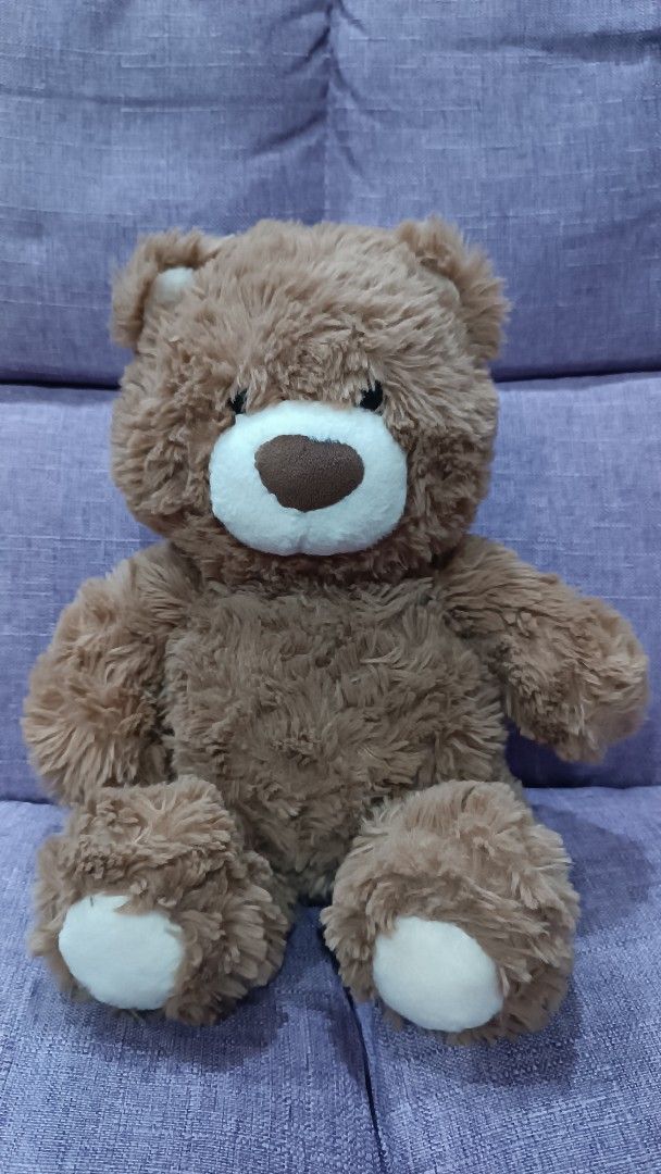 Miniso Brown Teddy Bear Plush Toy (Category: Plushies & Soft Toys) located in Quezon City. Submitted by fabricatebycp (Listing ID 1465730612, Image 1). Description: Fluffy brown teddy bear from Miniso. White snout, brown embroidered nose, and white paw pads. Measures 25cm / 10 inches tall. Tag still attached to the back. Soft plush material, super cuddly..