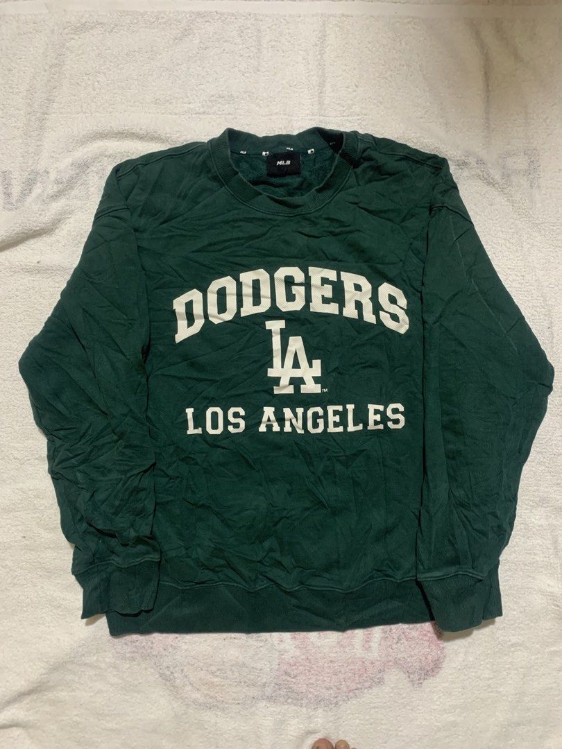 MLB Los Angeles Dodgers Green Sweatshirt (Category: Coats, Jackets and Outerwear) located in Iloilo. Submitted by johnpullan30303 (Listing ID 1465710028, Image 1). Description: - Brand: Major League Baseball (Genuine Merchandise) - Team: Los Angeles Dodgers - Color: Green with white chest print - Style: Long-sleeve crewneck sweatshirt with ribbed cuffs, collar, and hem - Condition: Good, with minor wrinkles from storage - Authentic inner tags att