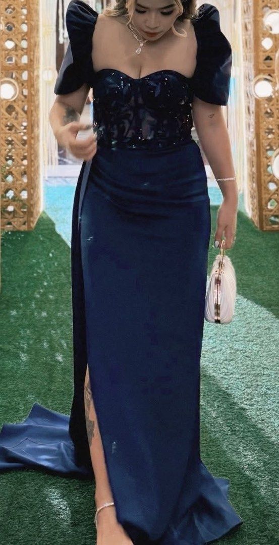 Moderm filipiniana dress (Category: Dresses) located in Pasig City. Submitted by jayveeeeee (Listing ID 1465652640, Image 2). Description: - Color: Navy blue - Design: Structured sheer bodice with dark floral embroidery and subtle sparkles - Skirt: Satin with a high leg slit and a short back train - Sleeves: Dramatic short puff sleeves - Closure: Back zipper - Size 26-28.