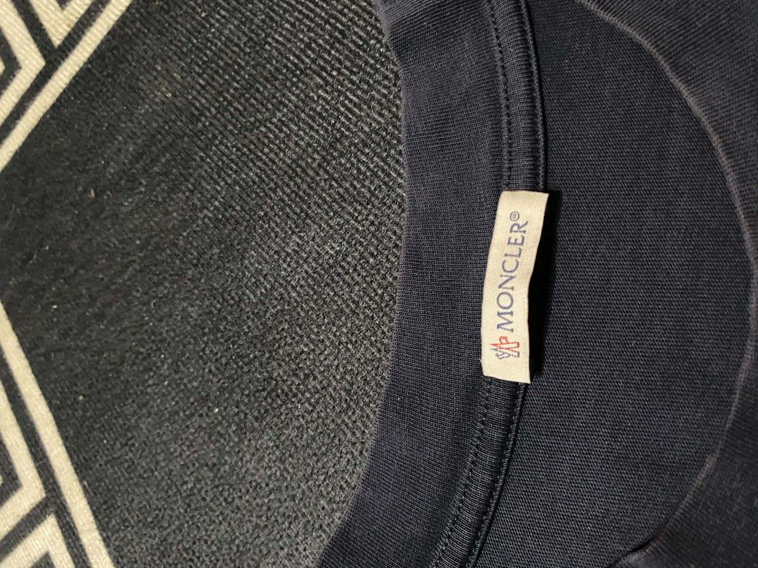 Moncler Script Logo (Category: Tshirts & Polo Shirts ) located in Manila. Submitted by thrift_sta.20 (Listing ID 1465674339, Image 2). Description: - Brand: Moncler - Color: Navy Blue - Fit: Regular fit, short sleeve - Material: Soft 100% cotton - Design: Red and blue script logo graphic on chest with embroidered shoulder patches - Details: Classic crew neck, interior tags with product code H10918C00042 83907 - Origin: Made in Turkey - Condition: