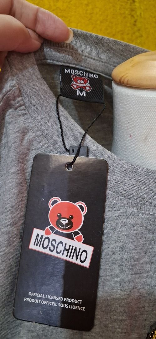 Moschino Grey Sequin Teddy Bear T-Shirt (Category: Shirts) located in Manila. Submitted by katkween23 (Listing ID 1465634075, Image 2). Description: - Brand new with tags (BNWT) - Color: Grey - Material: 100% Cotton - Fit: Regular crew neck, short sleeves - Details: Signature Moschino lettering on the neckline - Design: Eye-catching large sequin teddy bear graphic with 'This is not a Moschino toy' text.
