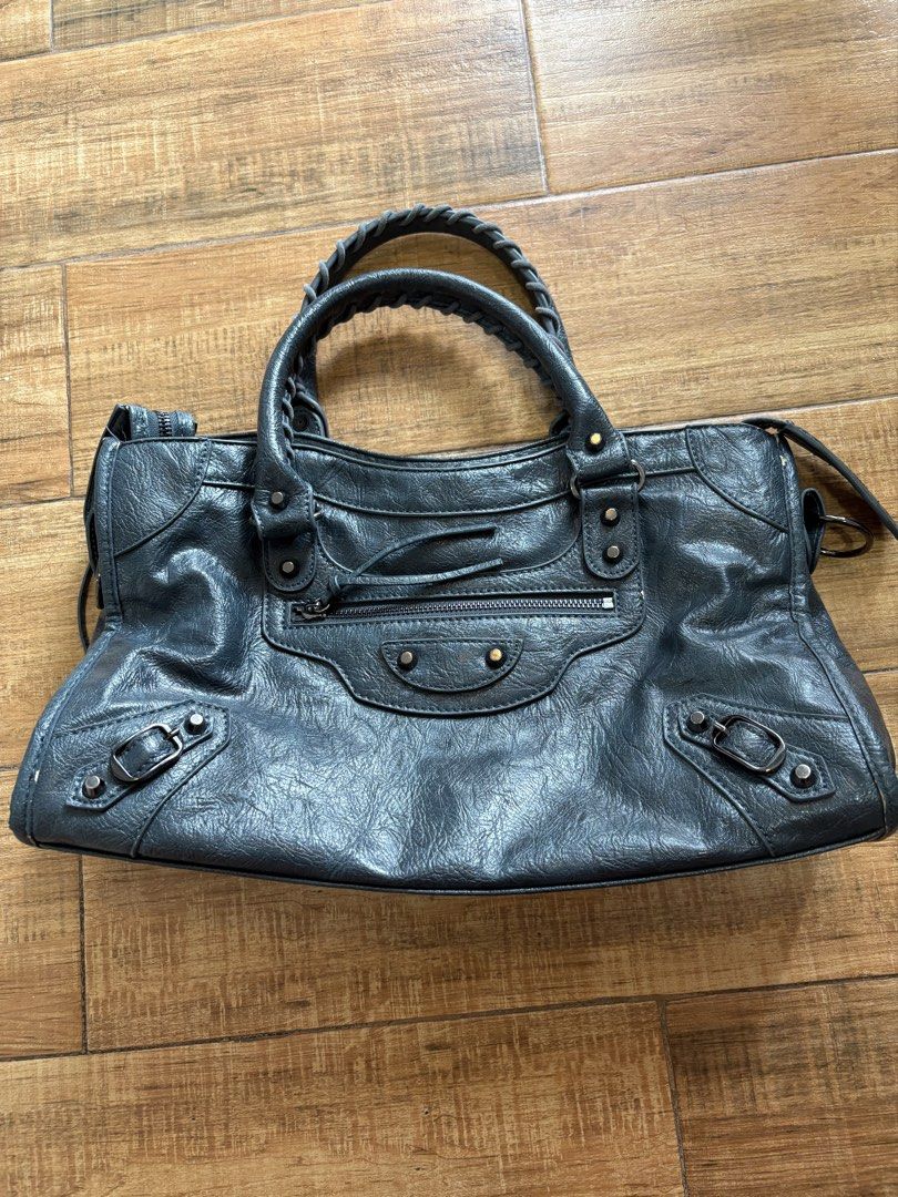 Motorcycle Bag (Category: Luxury Bags & Wallets) located in Makati City. Submitted by kirbybeltran (Listing ID 1465665808, Image 1). Description: - NGA - Balenciaga inspired Motorcycle Handbag - Material: Dark grey crumpled leather with dark fabric lining - Hardware & Accents: Brass studs, buckle accents, and front zip pocket - With few issues as seen on the photos.