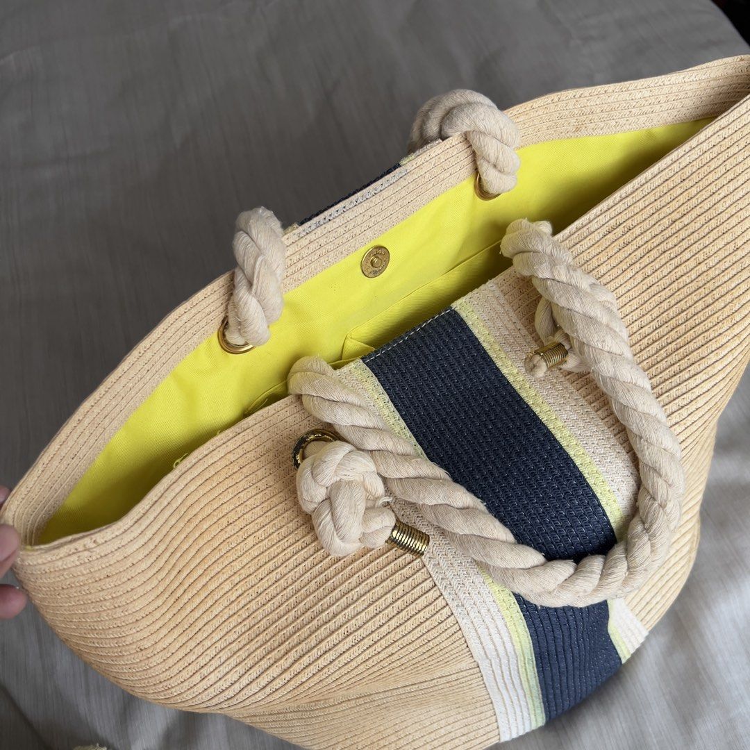 M&S Collection Striped Straw Shopper Bag (Category: Beach Bags) located in Pasig City. Submitted by jenscloset86 (Listing ID 1465636789, Image 1). Description: Mark & Spencer M&S Collection • Straw beach tote bag in beige with dark blue and yellow center stripe. • Thick twisted rope handles with knotted ends and gold-tone metal hardware. • Vibrant yellow fabric lining with internal slip pockets and a zippered pocket. • Liquid stain inside but not