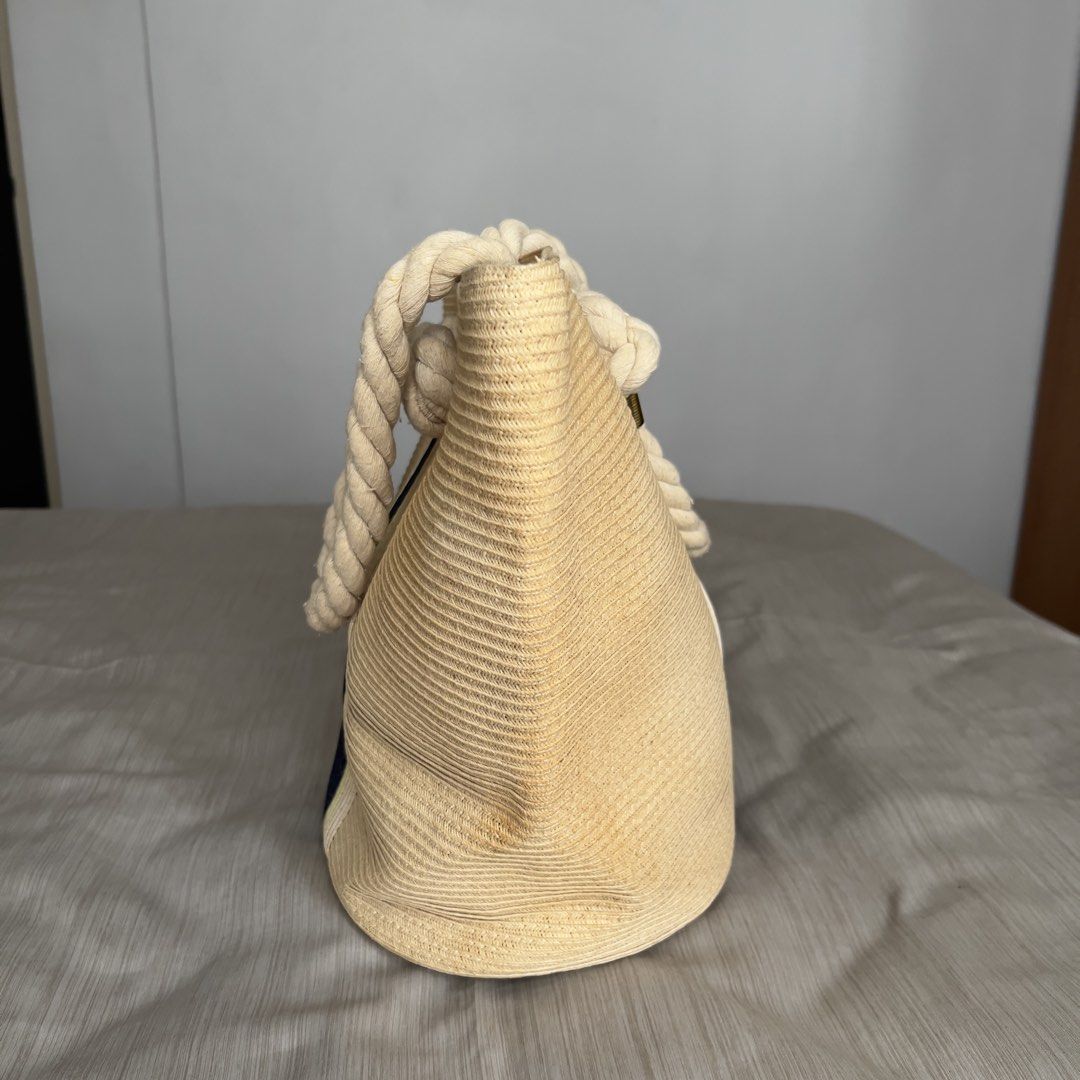 M&S Collection Striped Straw Shopper Bag (Category: Beach Bags) located in Pasig City. Submitted by jenscloset86 (Listing ID 1465636789, Image 3). Description: Mark & Spencer M&S Collection • Straw beach tote bag in beige with dark blue and yellow center stripe. • Thick twisted rope handles with knotted ends and gold-tone metal hardware. • Vibrant yellow fabric lining with internal slip pockets and a zippered pocket. • Liquid stain inside but not