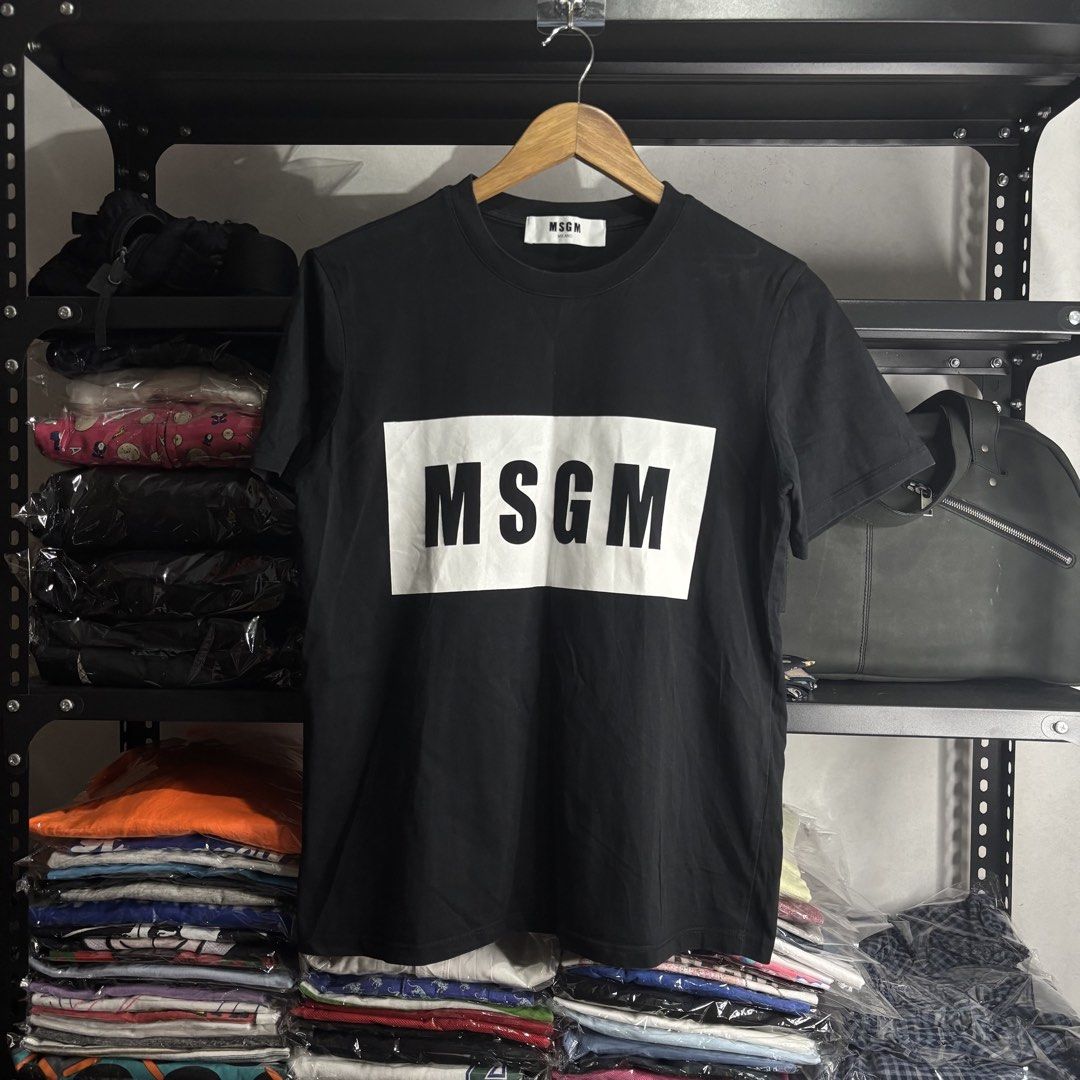 MSGM - Milano Black Logo T-Shirt (Category: Shirts) located in Cavite. Submitted by goodstayojan.cvt (Listing ID 1465718776, Image 1). Description: MSGM - Box Logo Shirt M on tag(18.5 x 25) Verygood Condition No flaws! - Brand: MSGM Milano - Color: Black with bold white box logo - Size: Medium (M) - Material: 100% premium cotton (soft & breathable) - Fit: Regular fit, classic crew neck - Condition: Brand new with tags/labels - Perfect for casual 