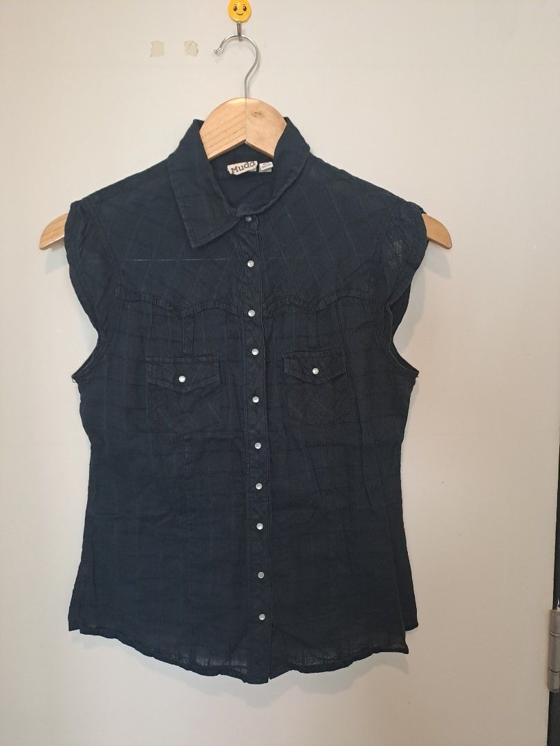 MUDD Black sleeveless (Category: Blouses) located in Manila. Submitted by joanbalde39643 (Listing ID 1465668994, Image 1). Description: The item pictured is a Mudd sleeveless button-down top featuring a distinct Western style design. It is constructed with classic single-point pointed front yokes, dual button-flap chest pockets, a subtle plaid pattern textured into the dark fabric, and a traditional button-up placket running down the front..