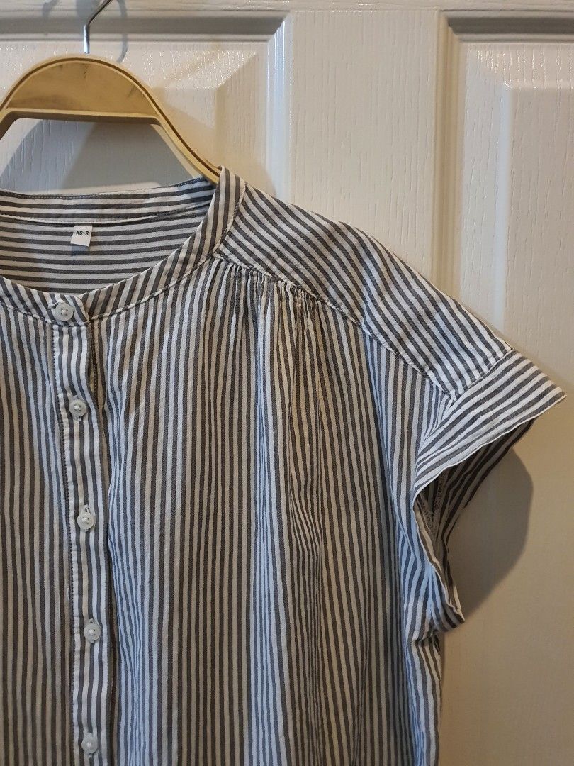 MUJI Striped Button Down Short Sleeve Blouse (Category: Blouses) located in Quezon City. Submitted by RepeatOnFleek (Listing ID 1465660185, Image 2). Description: - Brand: MUJI - Style: Short sleeve button-down shirt with classic grey and white stripes - Material: 100% cotton (super lightweight and breathable) - Fit: Relaxed fit, tagged size XS-S but may fit up to medium..kind of loose style .