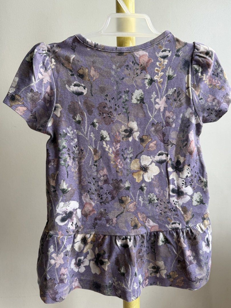 Name It Purple Floral Peplum Top (Category: Babies & Kids Fashion) located in Quezon City. Submitted by warmrabbit_414908 (Listing ID 1465594532, Image 3). Description: - Brand: Name It - Color: Dusty purple with all-over floral print - Size: Girls - Features: Short puff sleeves and cute ruffled peplum hem - Material: Soft cotton blend - Condition: Excellent, no stains or tears spotted - Perfect for everyday wear.
