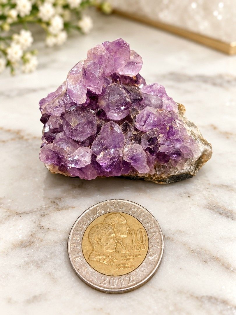 Natural Amethyst Crystal Cluster Mineral Specimen (Category: Precious Stones) located in Legazpi City. Submitted by riris.unique.finds (Listing ID 1465694820, Image 1). Description: - Type: Raw amethyst crystal cluster on matrix - Color: Rich deep purple with natural color variation - Condition: Pristine, clean crystal faces with zero damage - Display: Beautiful natural formation piece, perfect for home decor or collection - Size reference: Compa