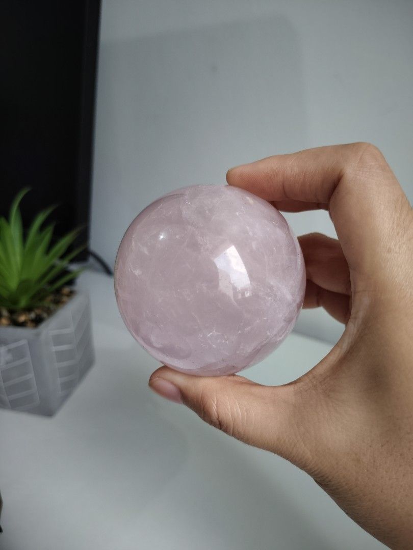 Natural Pink Rose Quartz Crystal Sphere Ball (Category: Precious Stones) located in Cavite. Submitted by lynlcb (Listing ID 1465653078, Image 1). Description: - Genuine rose quartz sphere with a soft pink color - Smooth, polished finish all over - Features natural internal fractures that catch the light beautifully - Compact size that fits nicely in the palm of your hand - Perfect for home decor, meditation, or crystal display - weight is 406g.