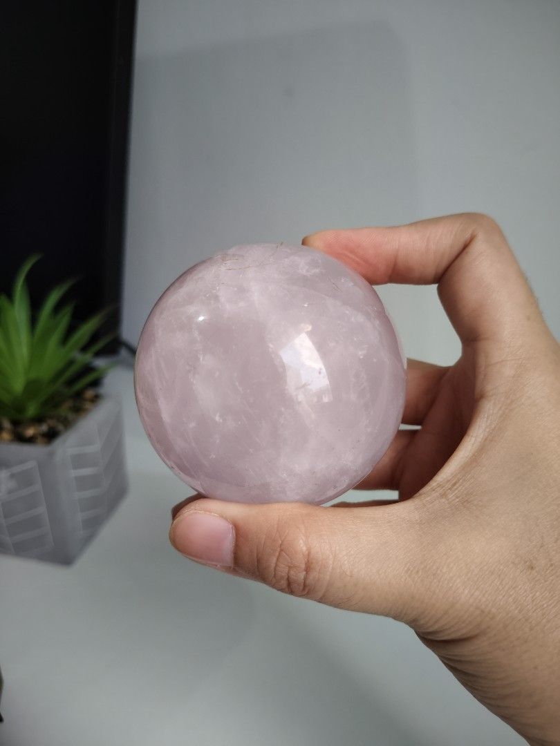 Natural Pink Rose Quartz Crystal Sphere Ball (Category: Precious Stones) located in Cavite. Submitted by lynlcb (Listing ID 1465653078, Image 2). Description: - Genuine rose quartz sphere with a soft pink color - Smooth, polished finish all over - Features natural internal fractures that catch the light beautifully - Compact size that fits nicely in the palm of your hand - Perfect for home decor, meditation, or crystal display - weight is 406g.