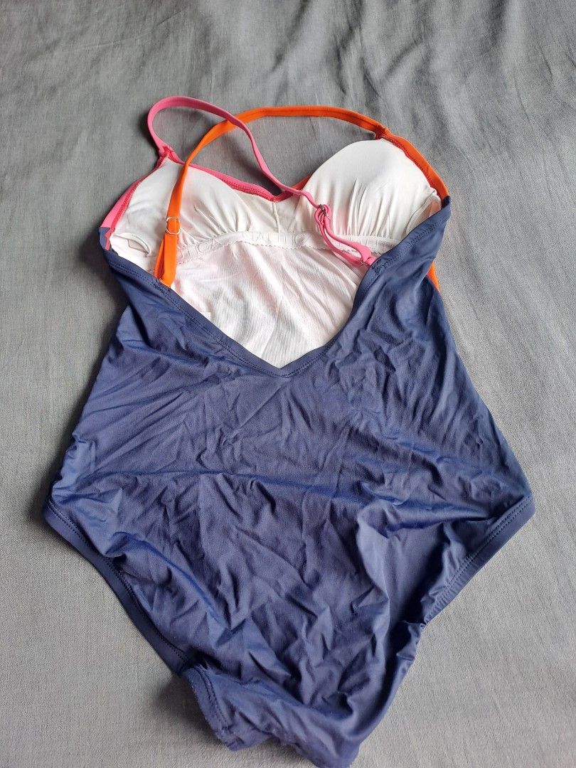 Nautica swimsuit (Category: Bikinis & Swimsuits) located in Manila. Submitted by joanbalde39643 (Listing ID 1465625896, Image 2). Description: This image shows the fabric care and content tags of a dark blue Nautica swimsuit with an orange accent piece. The clothing tag lists the following details about the item: Size: Medium.