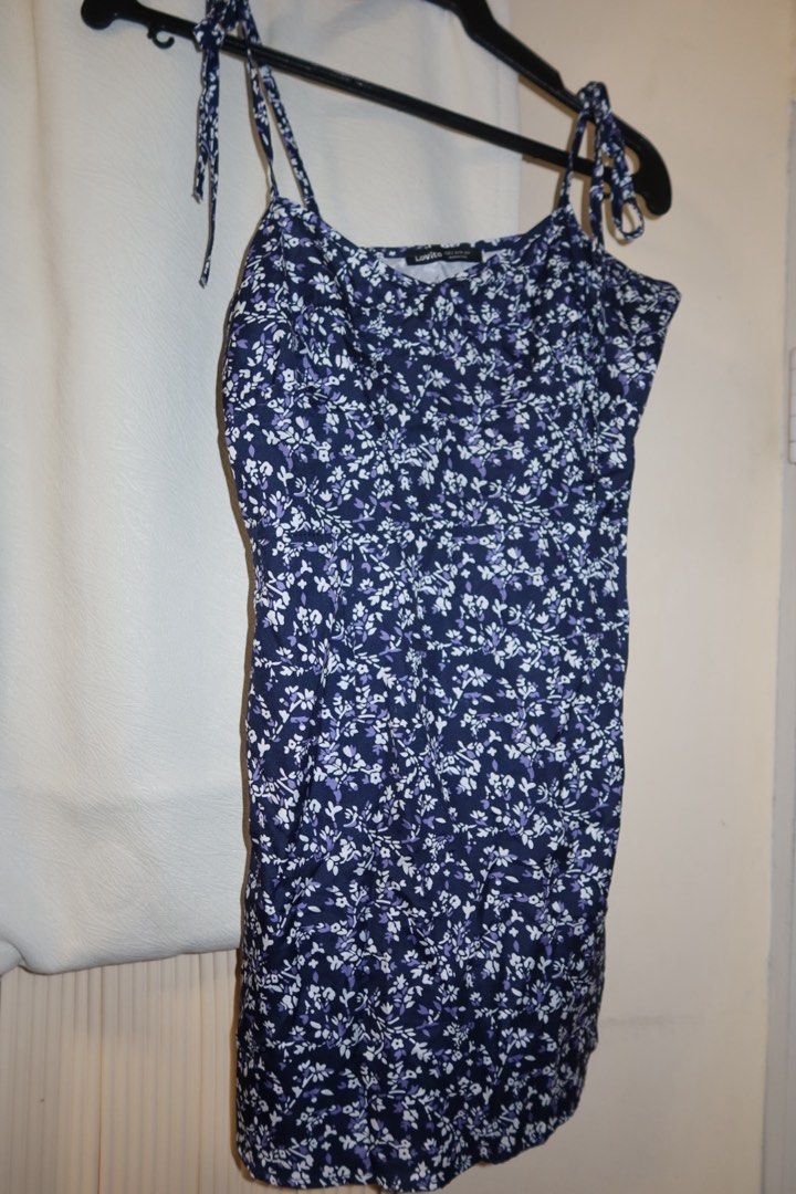 Navy Blue Floral Spaghetti Strap Mini Dress (Category: Dresses) located in Cavite. Submitted by mcjkim (Listing ID 1465679609, Image 1). Description: - Color/Pattern: Navy blue with dainty white and purple floral print - Design: Sweetheart neckline with adjustable tie-shoulder straps and comfortable smocked back panel - Fabric: Super lightweight and breezy - Condition: Worn once for a vacation, freshly washed and clean - Best for: Warm weather da