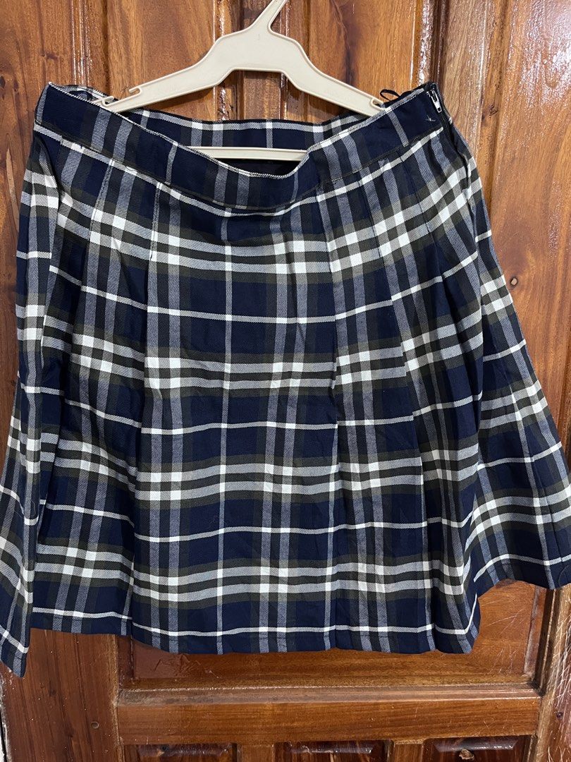 Navy Blue Plaid Pleated Skirt (Category: Skirts) located in Baguio. Submitted by gbwardrobe (Listing ID 1465613981, Image 1). Description: - Design: Classic pleated navy blue, white, and green plaid skirt - Fit: Mid-thigh length with a convenient side zipper closure - Material: Heavyweight fabric that holds its shape nicely - Styling: Great for school uniform looks, casual outfits, or pairing with oversized sweaters and basic tees.