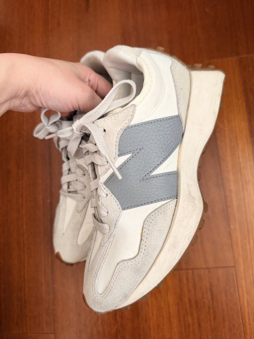 New Balance 327 White Grey Sneakers (Category: Sneakers) located in Quezon City. Submitted by hjane26 (Listing ID 1465637329, Image 2). Description: - Brand: New Balance - Model: 327 Lifestyle Sneakers - Colorway: Off-white and grey with textured grey oversized 'N' logo - Materials: Nylon base with premium suede overlays and grey laces - Soles: Chunky wedge midsole with signature lugged gum rubber outsole wrapping the heel - Condition: Pre-owned 