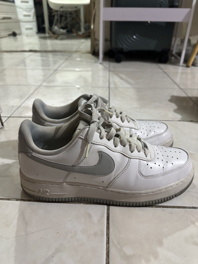 Nike Air Force 1 Low Grey White Size 10 (Category: Sneakers) located in Paranaque City. Submitted by fuckthepatriarchy (Listing ID 1465702811, Image 2). Description: - Brand: Nike - Model: Air Force 1 - Colorway: White and Grey - Size: Men's US 10 / UK 9 / EUR 44 - Features: Classic low-top design, lace-up fastening, metallic AF1 lace dubraes - Condition: Normal creasing on toe boxes, minor wear along midsoles - Soles: Clean traction outsoles, re