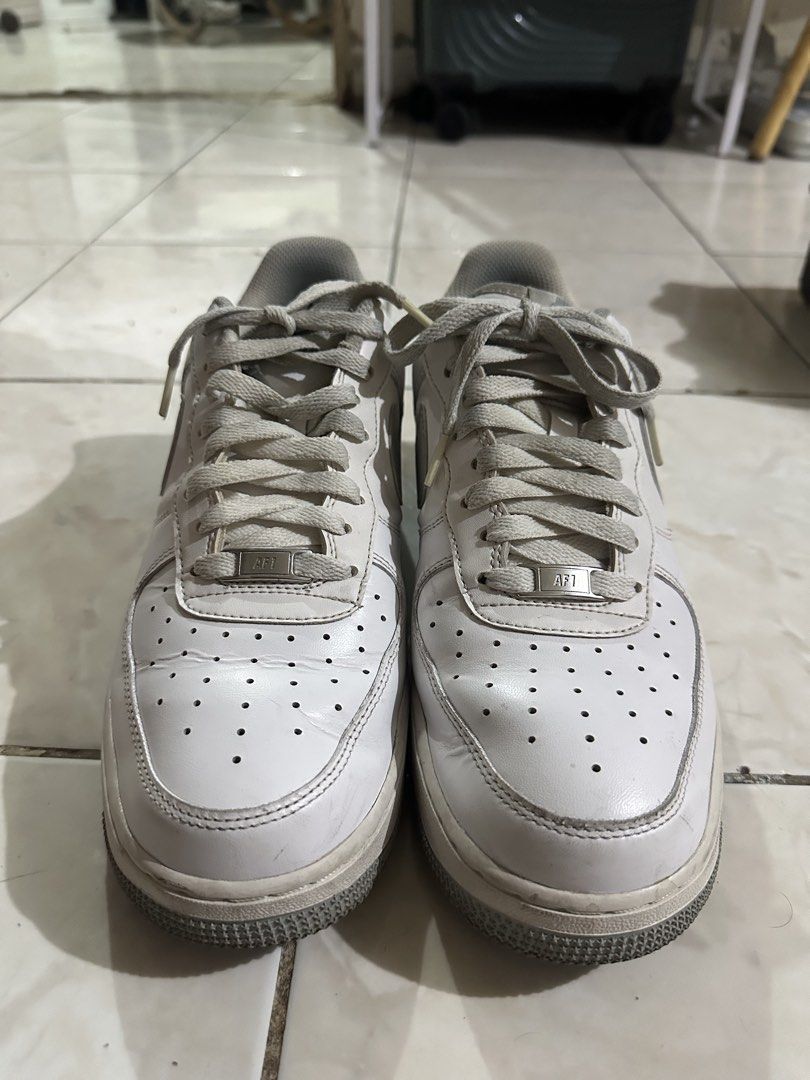 Nike Air Force 1 Low Grey White Size 10 (Category: Sneakers) located in Paranaque City. Submitted by fuckthepatriarchy (Listing ID 1465702811, Image 1). Description: - Brand: Nike - Model: Air Force 1 - Colorway: White and Grey - Size: Men's US 10 / UK 9 / EUR 44 - Features: Classic low-top design, lace-up fastening, metallic AF1 lace dubraes - Condition: Normal creasing on toe boxes, minor wear along midsoles - Soles: Clean traction outsoles, re