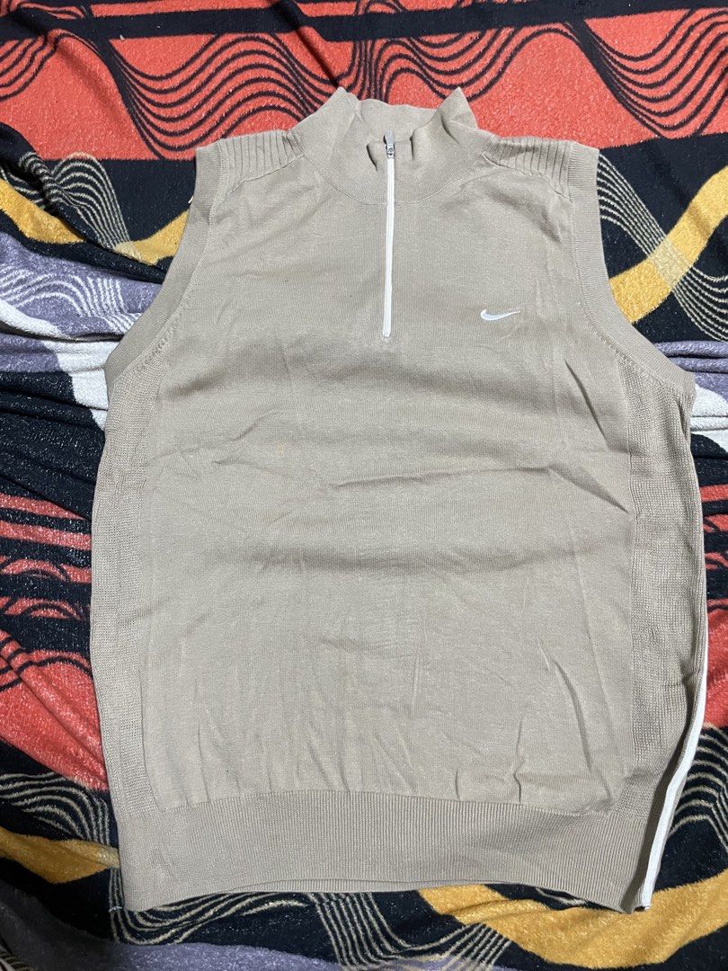 Nike Beige Half Zip Knit Vest (Category: Vests) located in Mandaue City. Submitted by anthony457 (Listing ID 1465645462, Image 1). Description: - Authentic Nike knit sleeveless vest in a versatile beige color - Stylish half-zip mock neck collar with embroidered white swoosh on the chest - Classic ribbed hem and armholes for a snug fit - Lightweight layering piece ideal for golf, sports, or casual outfits - Condition: Excellent / Ready to wear.