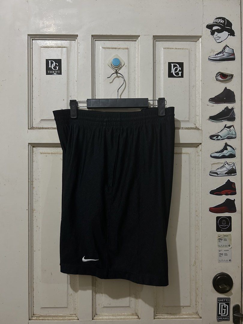 Nike Black Athletic Shorts (Category: Shorts) located in Pasay City. Submitted by deguzmanjay (Listing ID 1465675536, Image 1). Description: - Brand: Nike - Color: Black - Size: Standard fit - Features: Elastic waistband with adjustable drawstring, iconic white embroidered Swoosh logo on the lower left leg - Material: Lightweight, breathable mesh-textured fabric - Best for: Gym workouts, sports training, or casual streetwear - Condition: Clean, e