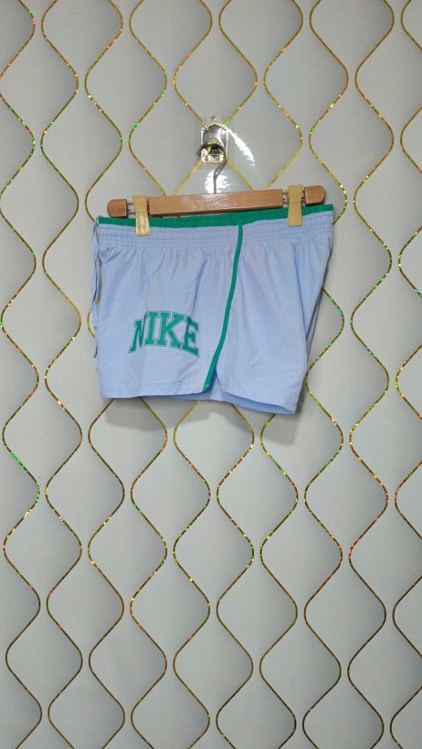 Nike Blue and Green Athletic Shorts (Category: Activewear) located in Manila. Submitted by zariyah.1986 (Listing ID 1465595524, Image 3). Description: - Brand: Nike - Color: Light blue with green contrast piping and waistband - Features: Large retro Nike logo on left leg, lightweight fabric, elastic waistband with adjustable drawstring - Origin: Made in Cambodia -with inner.