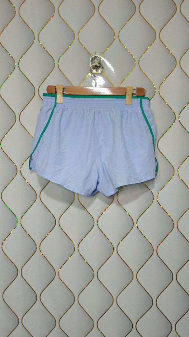 Nike Blue and Green Athletic Shorts (Category: Activewear) located in Manila. Submitted by zariyah.1986 (Listing ID 1465595524, Image 2). Description: - Brand: Nike - Color: Light blue with green contrast piping and waistband - Features: Large retro Nike logo on left leg, lightweight fabric, elastic waistband with adjustable drawstring - Origin: Made in Cambodia -with inner.