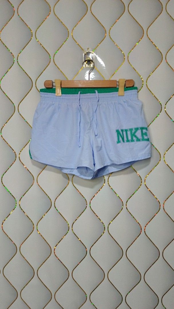 Nike Blue and Green Athletic Shorts (Category: Activewear) located in Manila. Submitted by zariyah.1986 (Listing ID 1465595524, Image 1). Description: - Brand: Nike - Color: Light blue with green contrast piping and waistband - Features: Large retro Nike logo on left leg, lightweight fabric, elastic waistband with adjustable drawstring - Origin: Made in Cambodia -with inner.