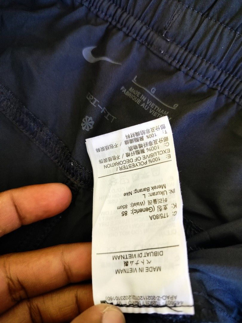 Nike Dri-FIT Black Shorts Size L (Category: Shorts) located in Manila. Submitted by gerald_quinto (Listing ID 1465709013, Image 3). Description: - Brand: Nike - Style: Dri-FIT athletic shorts - Color: Black with large white striped Nike swoosh logo on lower leg - Size: Large (L) -Waist 30-38 -Length 19 - Material: 100% polyester - Features: Elastic waistband with adjustable drawstring - Origin: Made in Vietnam - Condition: Clean inside and out, e