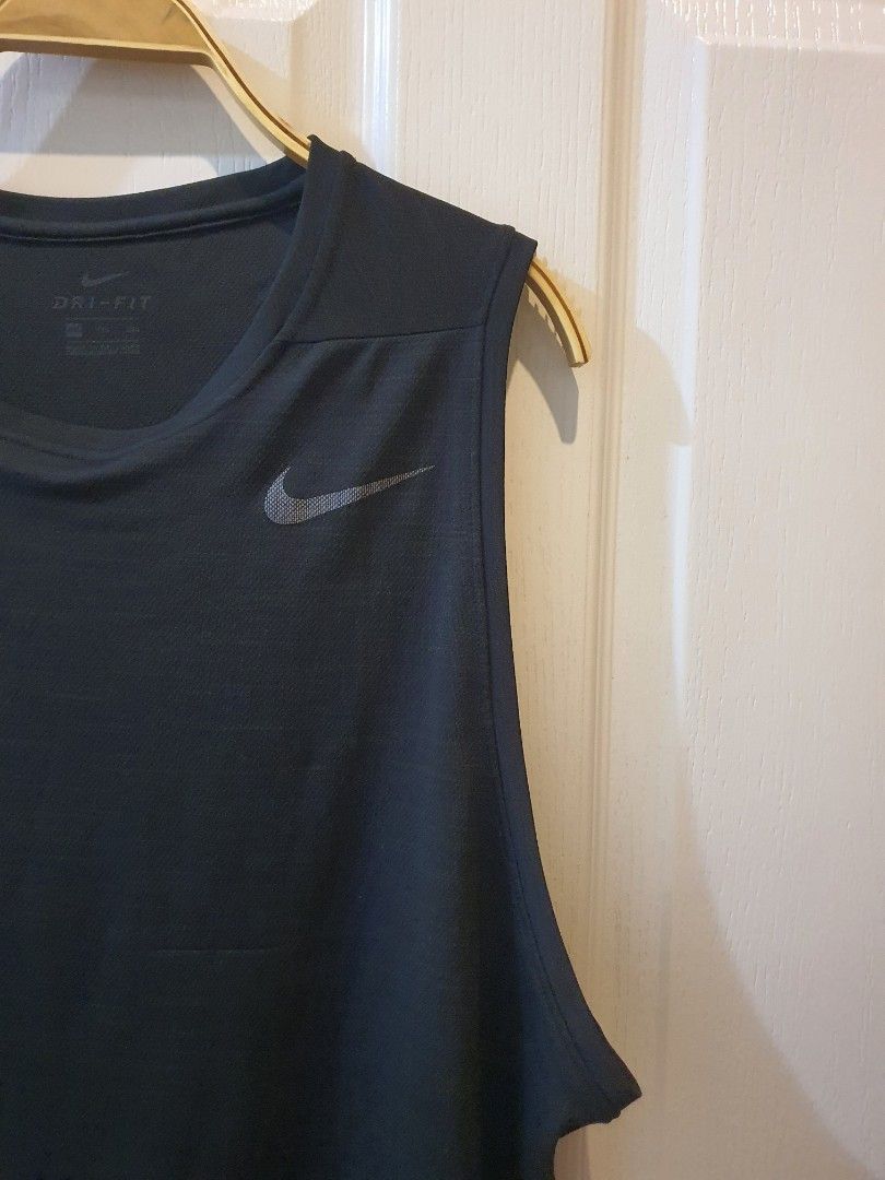 NIKE Dri-FIT Black Workout Tank Top (Category: Activewear) located in Quezon City. Submitted by RepeatOnFleek (Listing ID 1465612142, Image 3). Description: - Brand: Nike - Item: Black training tank top - Size: XXL - Material: 100% polyester with Dri-FIT technology - Features: Lightweight, sleeveless for full arm movement, and iconic chest Swoosh logo -Logo not cracked - Condition: Like new / Great for gym sessions and runs.
