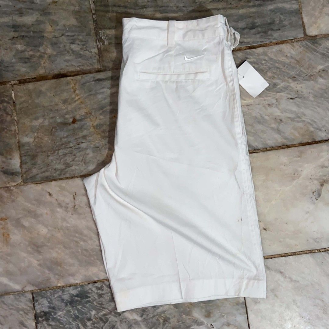 Nike Golf Dri-Fit White Shorts Size M (Category: Shorts) located in Manila. Submitted by ulober213 (Listing ID 1465581791, Image 3). Description: - Brand: Nike Golf - Color: White - Size: Men's Medium (32" waist) - Material: Dri-FIT technology for cooling and dryness - Closure: Button waist with zipped fly - Pockets: Back welt pockets (one with button closure) - Branding: Embroidered Nike swoosh above the back right pocket - Condition: Clean, ver